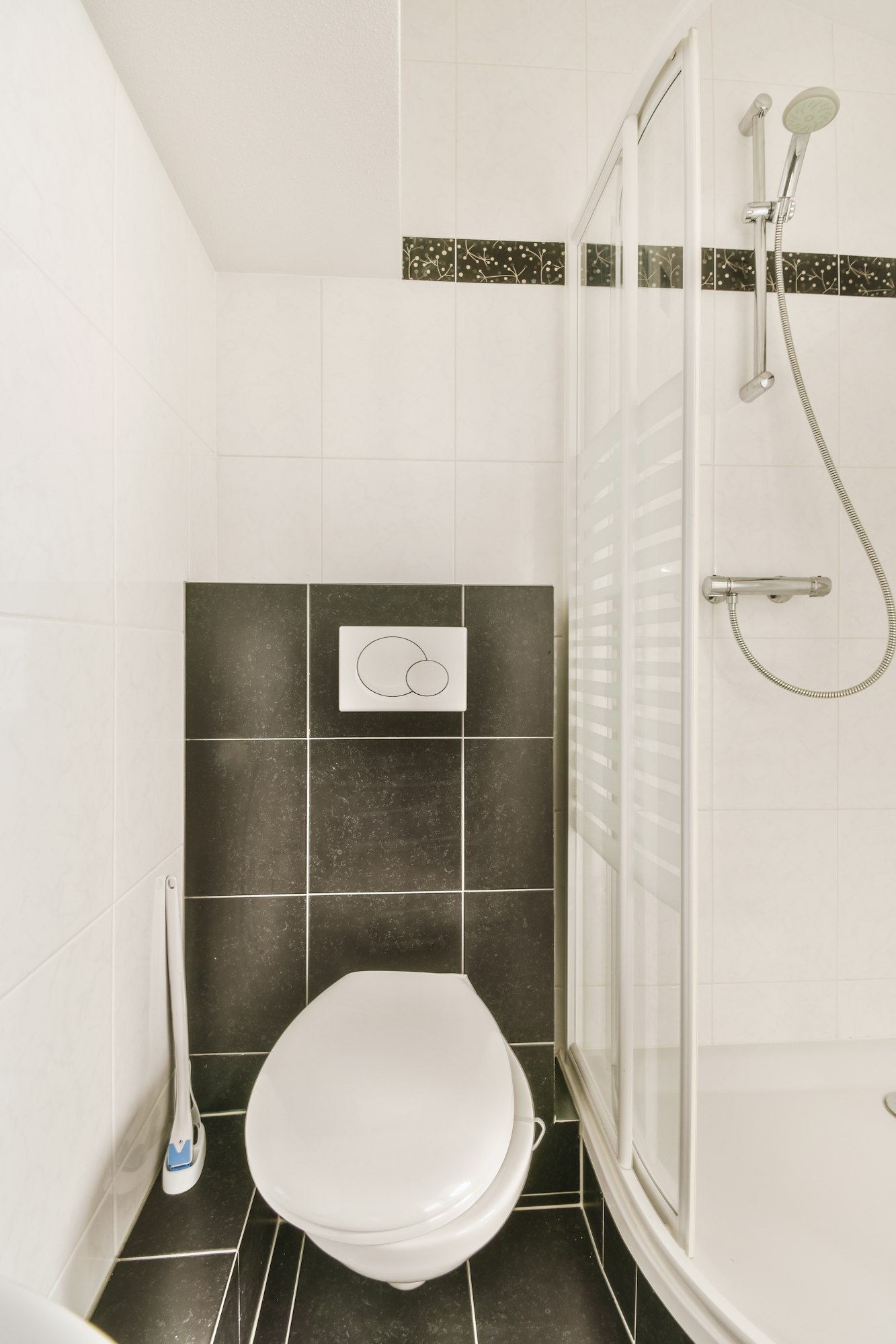 Bathroom interior finished with ceramic black and white tiles