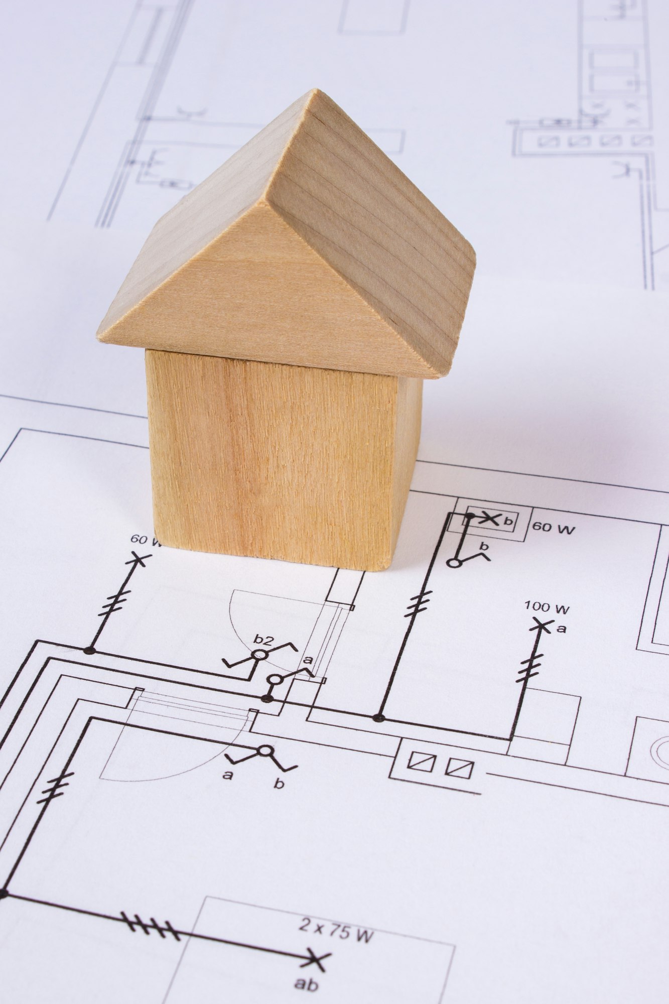 House of wooden blocks on construction drawing of house, building house concept