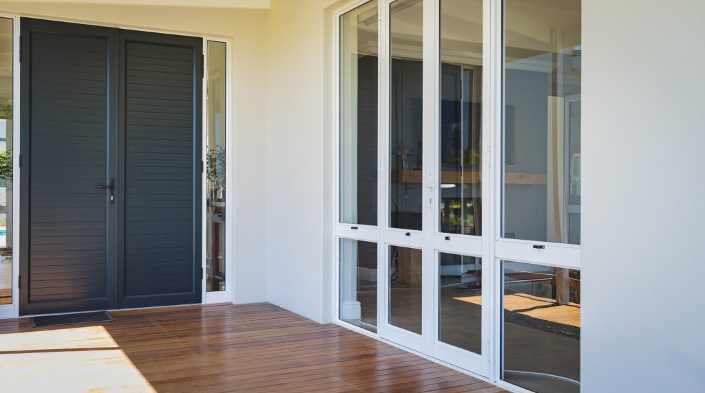 Empty porch with doors at modern home on a sunny day